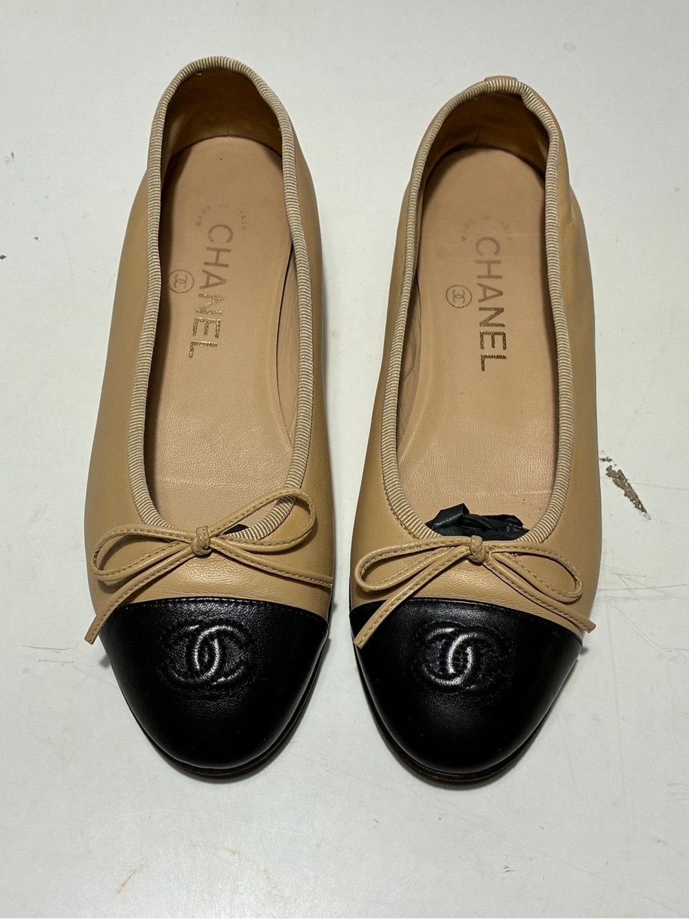 CHANEL Beige Leather Ballet Flats with Black Cap Toe and CC Logo